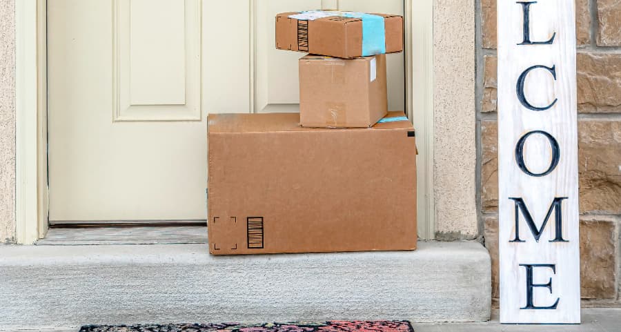 Boxes by the door of a residence with a welcome sign in Concord